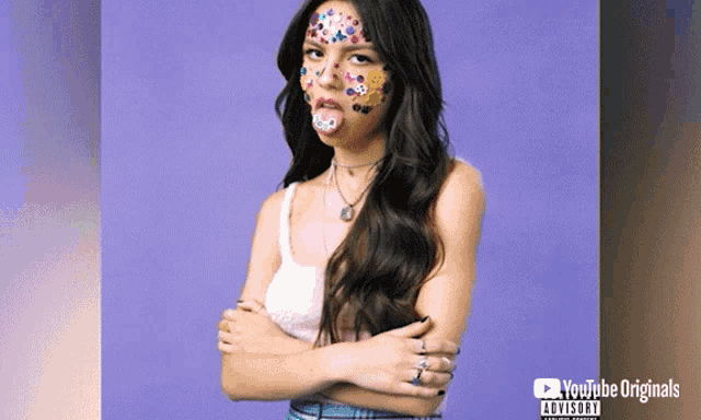 a woman with stickers on her face is on a youtube originals ad