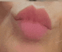 a close up of a woman 's pink lips with lipstick on them .