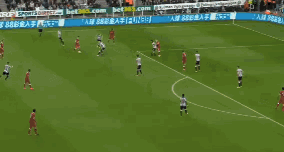a soccer game is being played on a field with advertisements on the side of the field