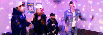 a group of people are dancing in a room with a lot of lights .