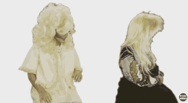 a woman in a wig is standing next to another woman in a wig