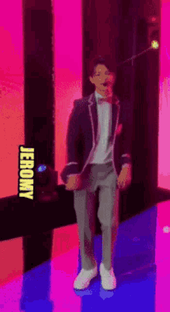 a man in a suit and bow tie is dancing in front of a sign that says jeromy on it