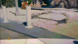 a blurry picture of a person standing on a sidewalk in front of a fence