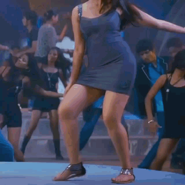 a woman in a short dress is dancing in a club