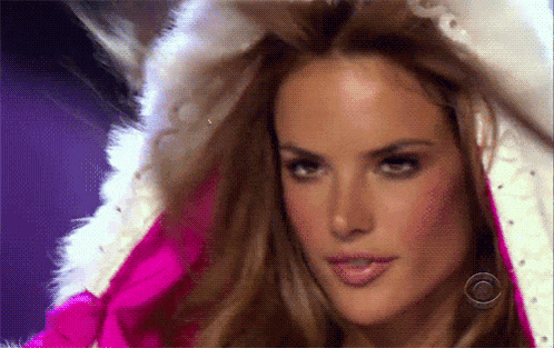 a close up of a woman wearing a fur coat