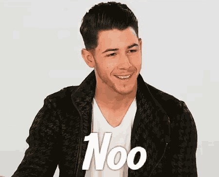 a young man wearing a black jacket and a white shirt is smiling and says noo .