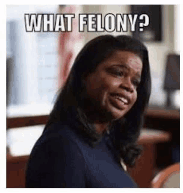 a woman is smiling and making a funny face with the words `` what felony '' written on her face .