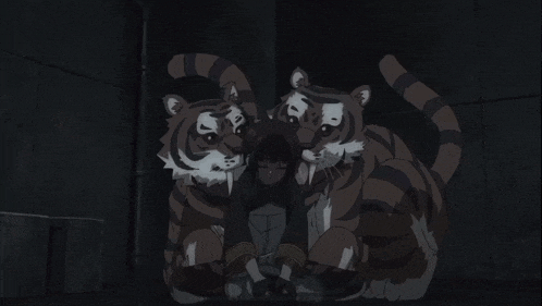 a woman is being held by two tigers in the dark