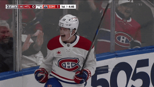a hockey player in a red white and blue jersey celebrates his goal
