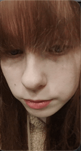 a close up of a girl with red hair