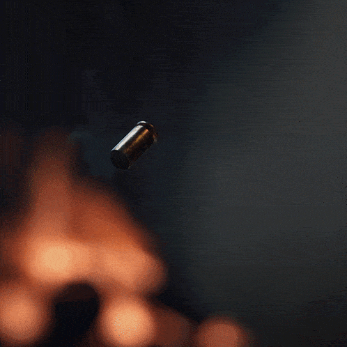 a bullet is falling into a puddle on the ground