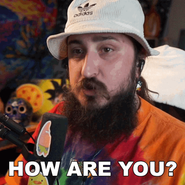 a man with a beard wears an adidas hat