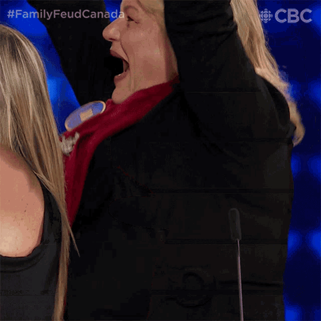 a woman is laughing with her arms in the air and the hashtag familyfeudcanada