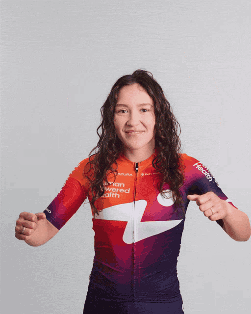 a woman wearing a jersey that says human powered health on it