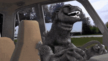 a monster is sitting in the driver 's seat of a vehicle