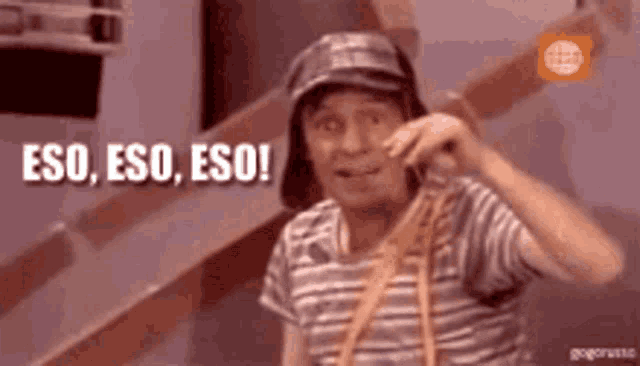 a man wearing a hat and a striped shirt is talking on a cell phone and saying eso , eso , eso !