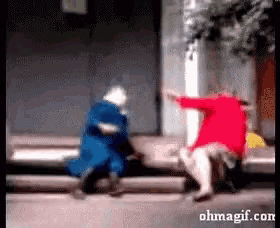 a woman in a red dress is standing next to a woman in a blue coat