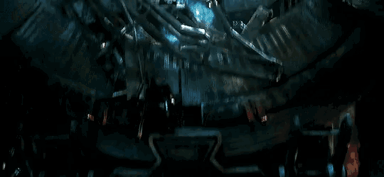 spider-man is flying through the air in a dark room with a lot of spiders .
