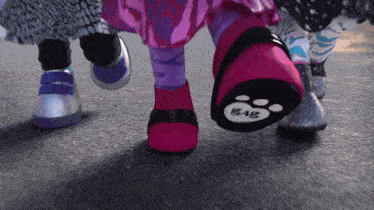 a close up of a person 's feet with a paw print that says kaiz on it