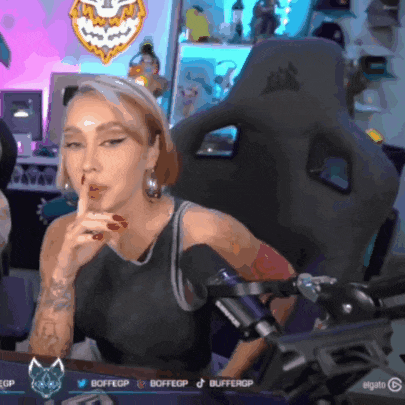 a woman sitting in front of a corsair gaming chair making a shhh gesture