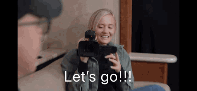 a woman sitting on a couch holding a camera with the words let 's go on the bottom