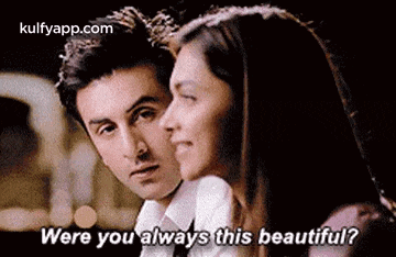 a man and a woman are looking at each other and the woman is asking if the man is always this beautiful .