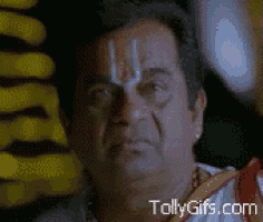 a close up of a man 's face with the website tollygifs.com visible in the corner