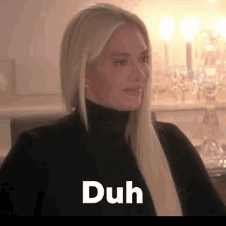 a woman with long blonde hair is wearing a black turtleneck and the word duh is on the bottom