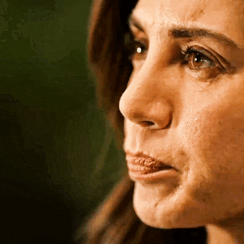a close up of a woman 's face with a slight smile on her face