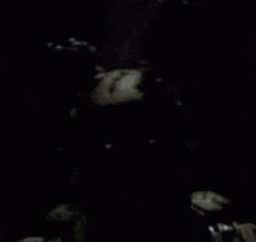 a black and white photo of a person 's face in the dark
