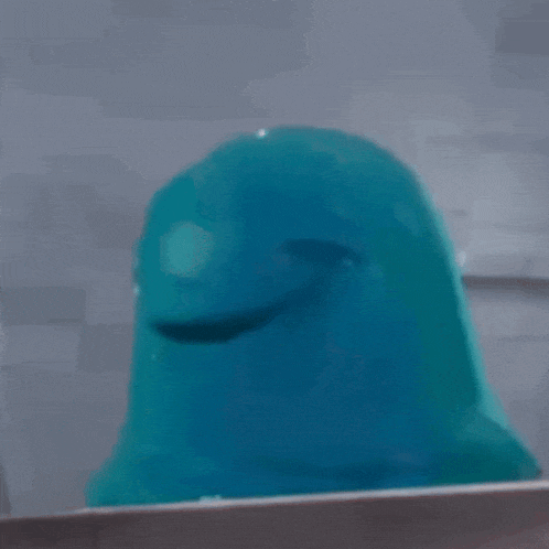a blue cartoon character with a red eye is looking out a window .