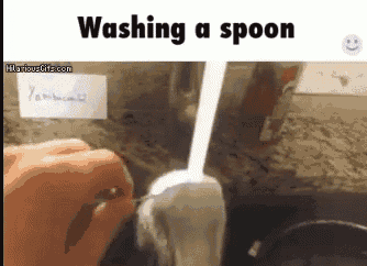 a picture of a person washing a spoon in a kitchen sink