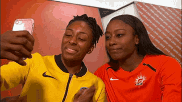 two women are taking a selfie together and one is wearing a canada shirt