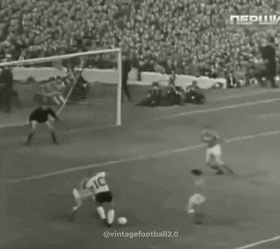 a black and white photo of a soccer game with a goalie wearing a number 15 jersey
