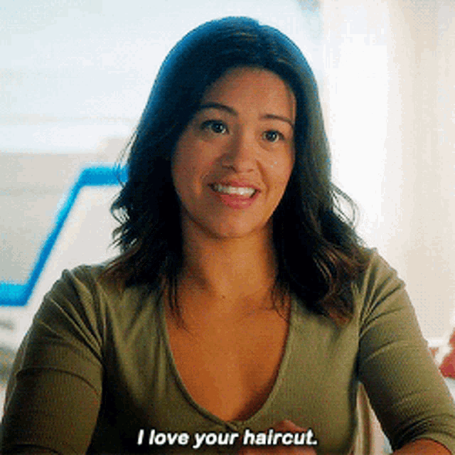 a woman says i love your haircut in a green shirt