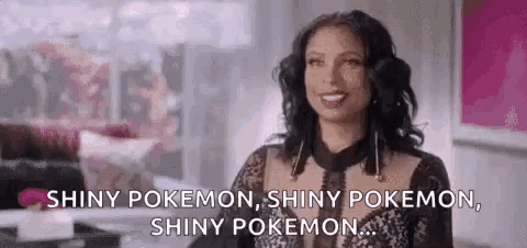a woman in a black dress is smiling and talking about shiny pokemon .