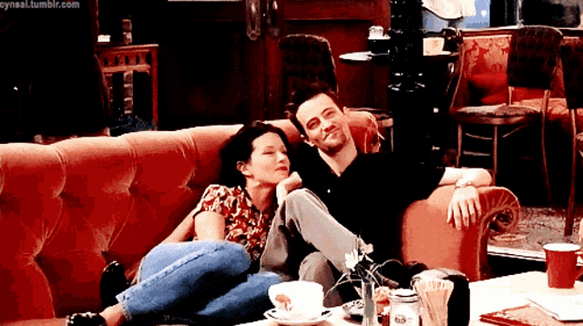 a man and a woman are laying on a couch with the url cynnal.tumblr.com visible
