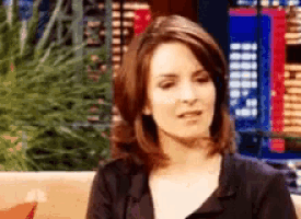 a woman sitting on a couch with a blurred background