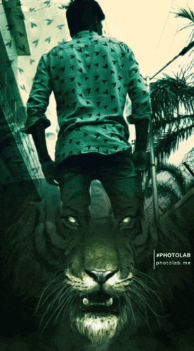 a photo of a man standing next to a tiger with the hashtag #photolar