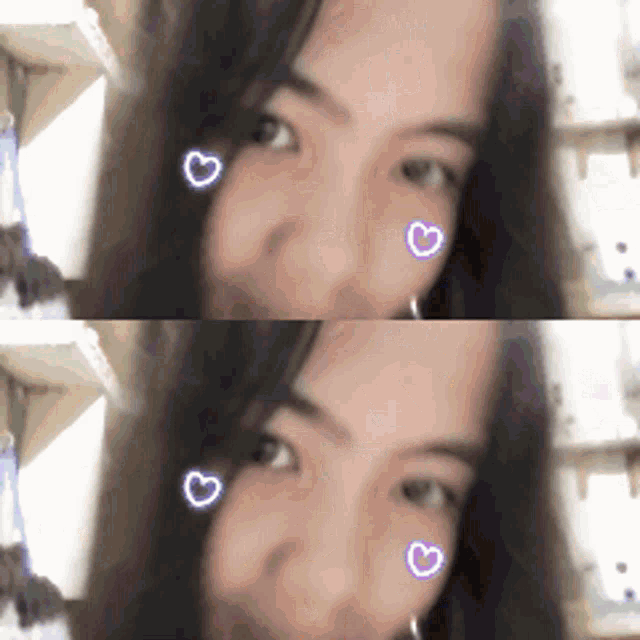 a close up of a woman 's face with hearts on her cheeks .