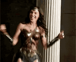 a woman in a wonder woman costume is dancing and smiling .