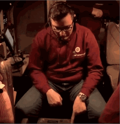 a man wearing a red sweatshirt that says simply on the front