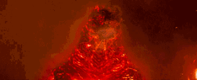 a large fire is burning in the dark and looks like the sun