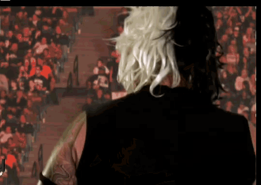a man with a tattoo on his arm is playing a guitar