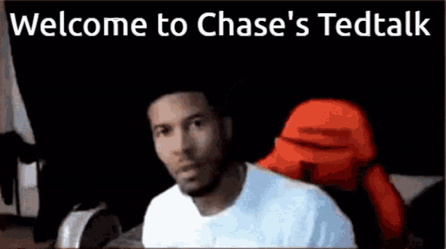 a man in a white shirt is smiling in front of a sign that says welcome to chase 's tedtalk .