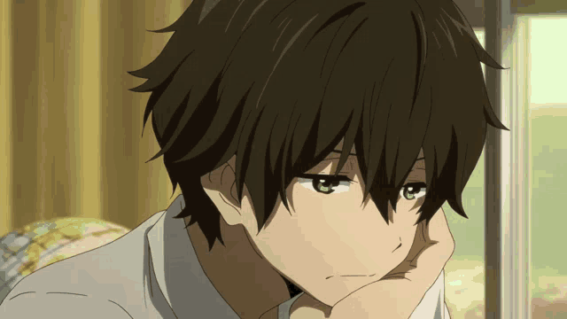 a close up of a person with their hand on their chin