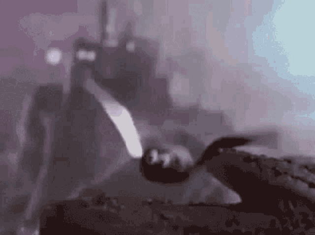 a man in a tuxedo is laying on his back in a dark room .