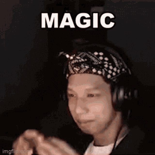 a man wearing headphones and a bandana is making a funny face while playing a video game .