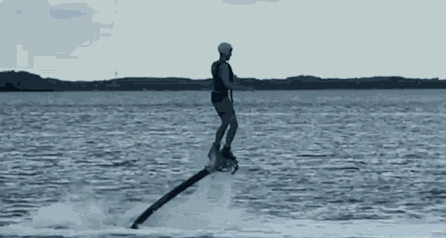 a man is flying through the air on a water jet board .