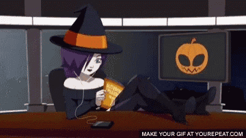 a girl in a witch hat is sitting at a desk eating potato chips